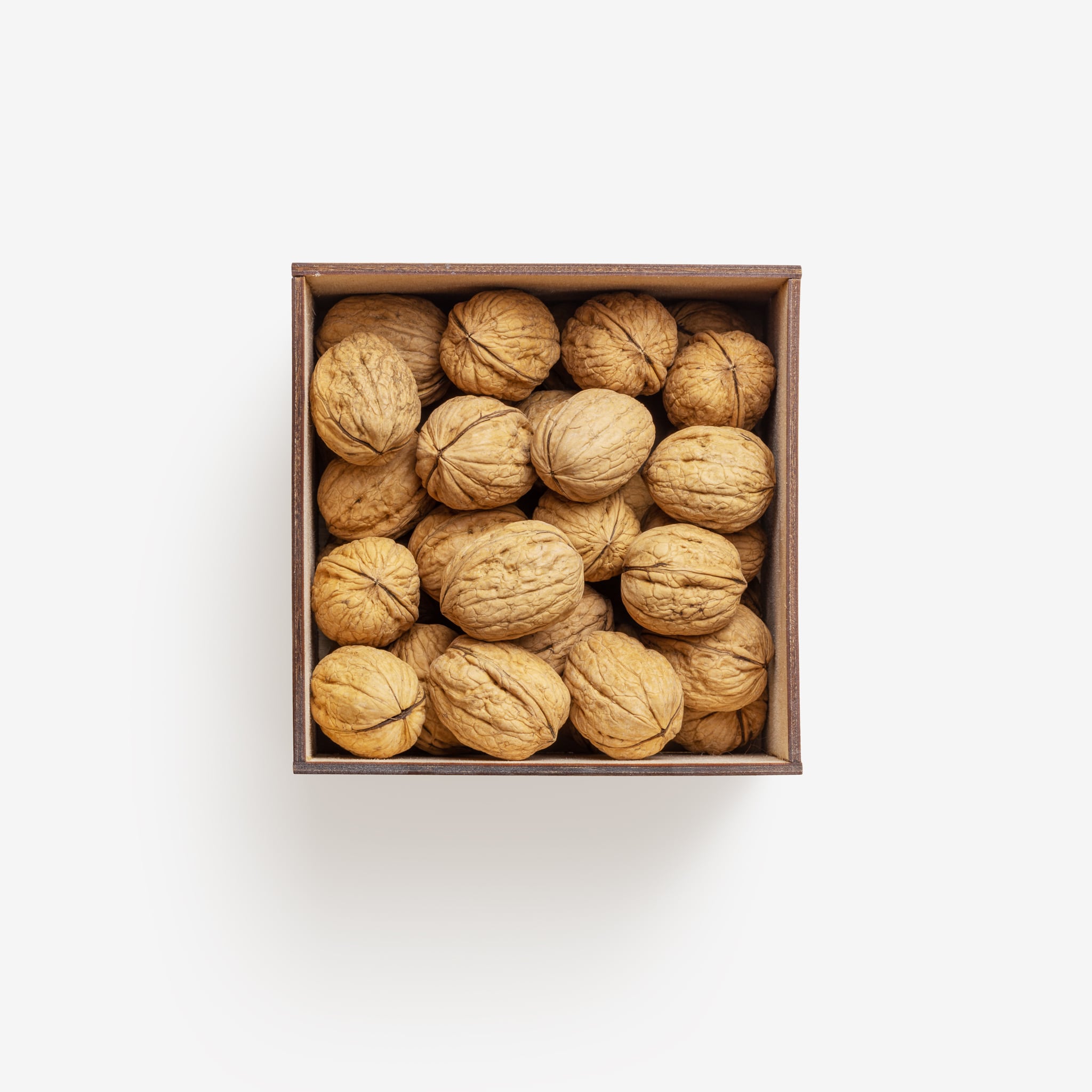 Clean Isolated PSD image of Box of walnuts on transparent background with separated shadow